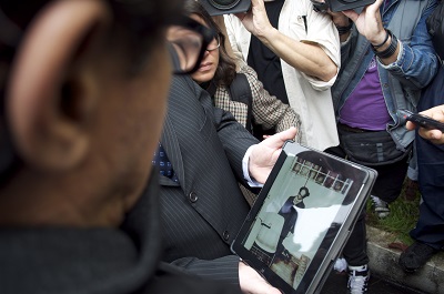 O fotógrafo do falso suicídio de Vladimir Herzog analisa a imagem feita por ele em um tablet durante visita ao Doi-Codi 